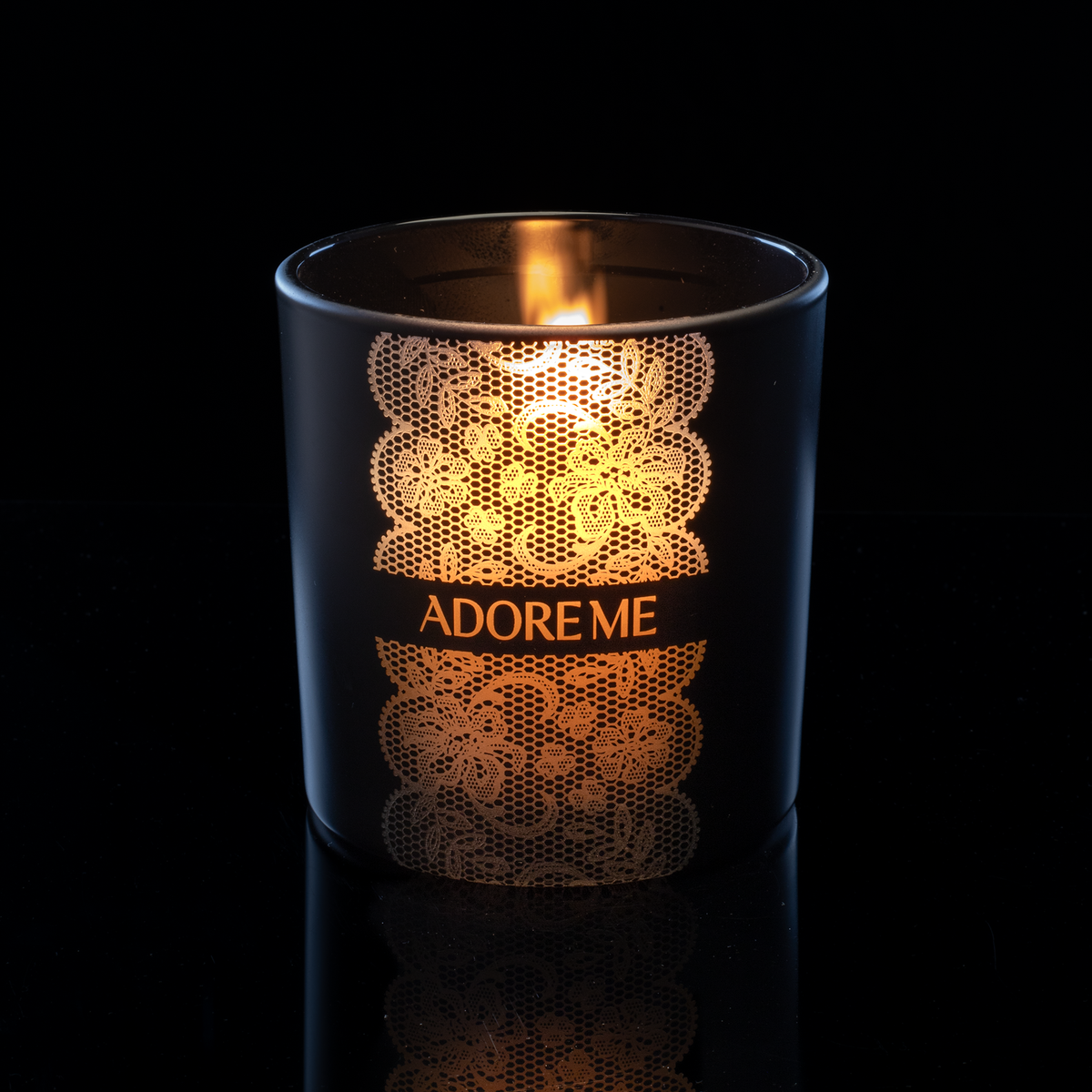 14 oz. Black glass candle with custom engraved logo from Bath Promotions, shown lit — Lit version