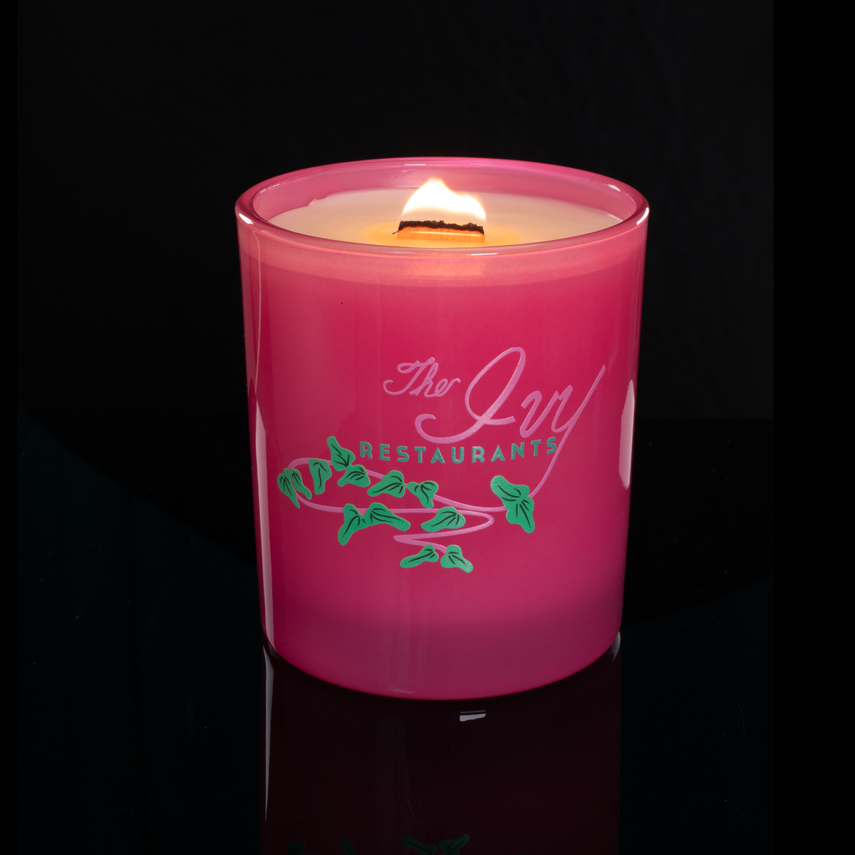 14 oz. Pink glass candle with custom printed logo from Bath Promotions, shown lit — Lit version