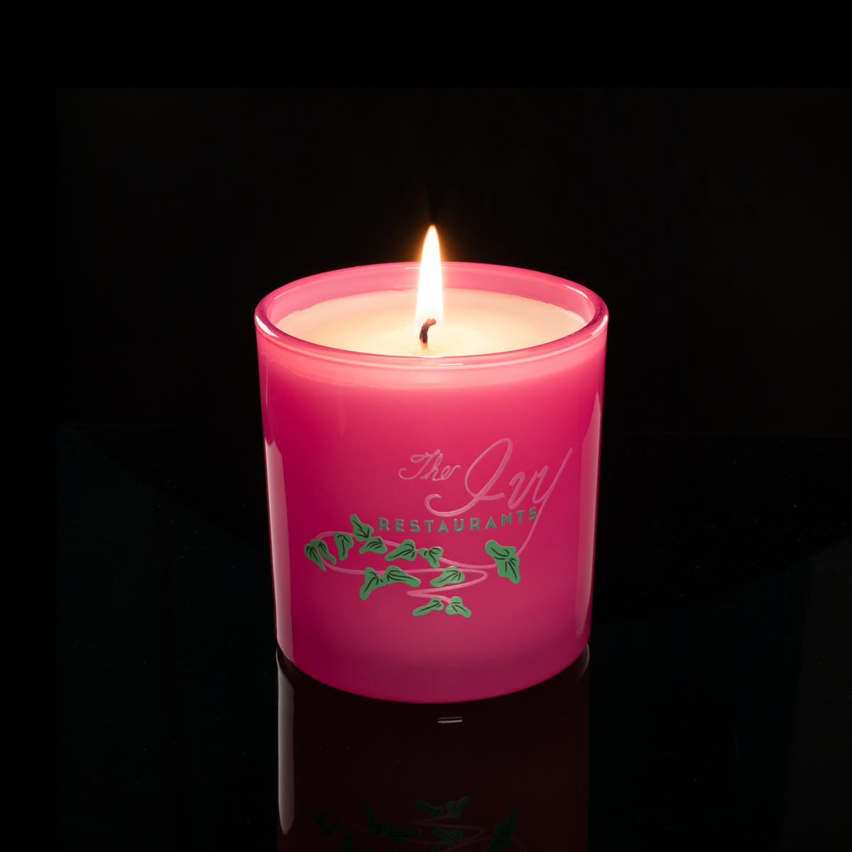9 oz. Pink glass candle with custom printed logo from Bath Promotions, shown lit — Lit version