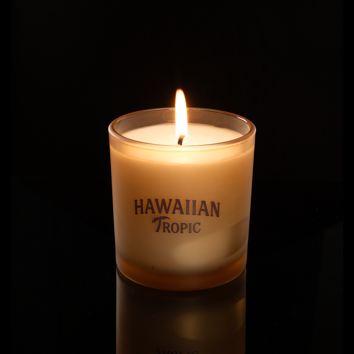 9 oz. Sand glass candle with custom printed logo from Bath Promotions, shown lit — Lit version