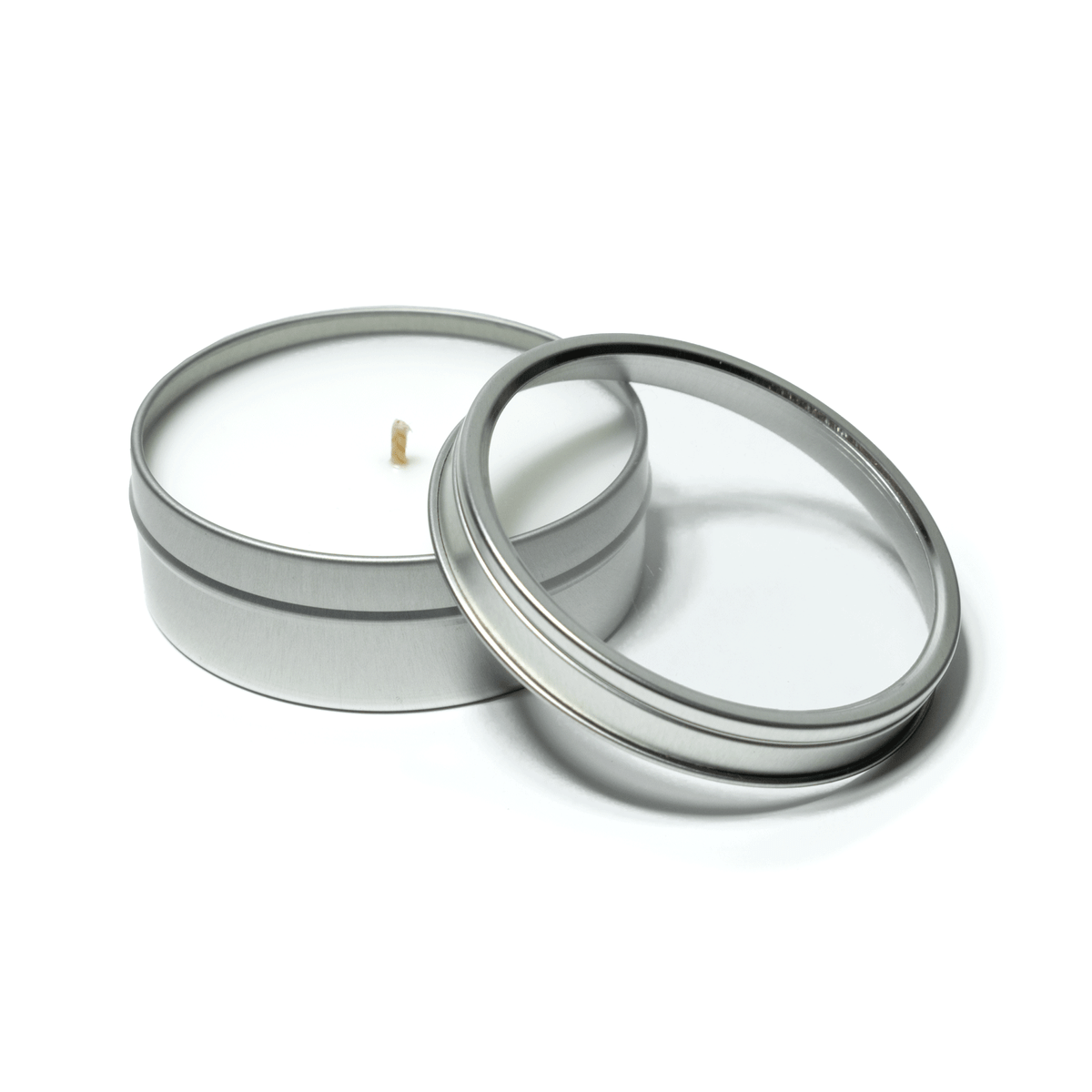 4 oz open silver tin candle with white wax and cotton wick, alongside its clear lid.