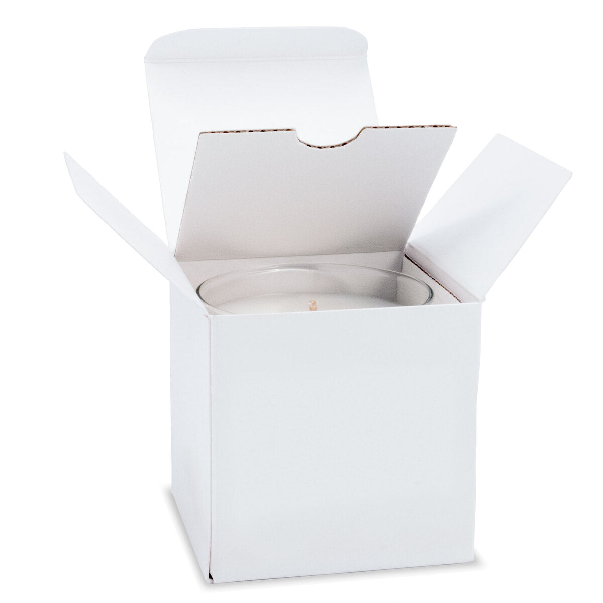 6 oz clear glass candle with white wax and cotton wick nestled inside an open white gift box with folded flaps.