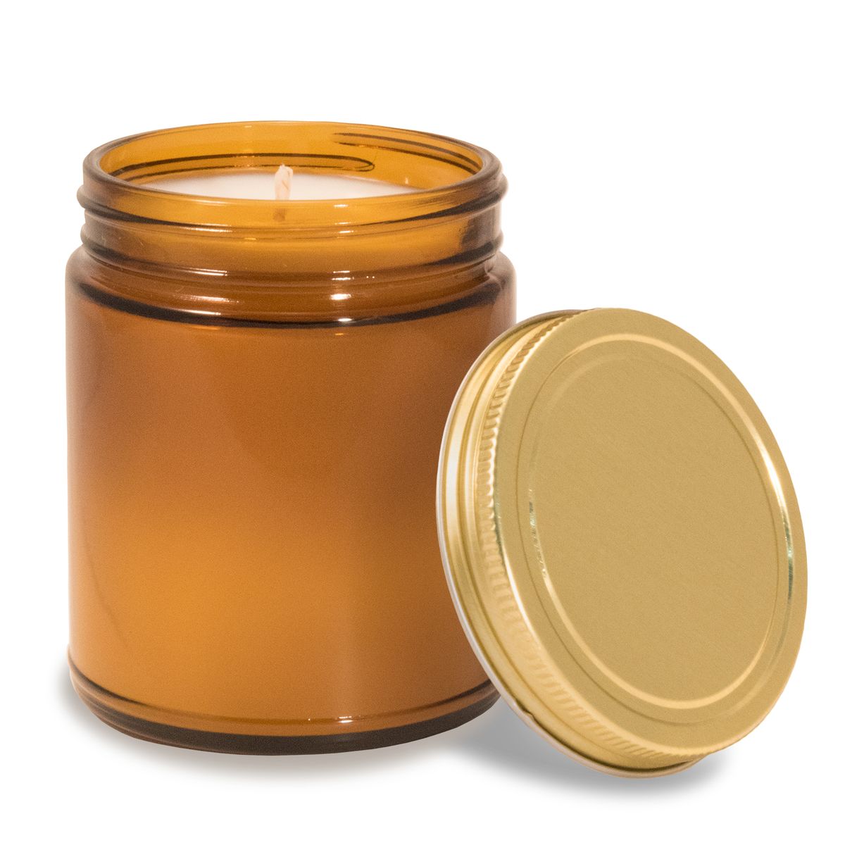 8 oz amber glass apothecary jar candle with gold screw-on lid off to the side.