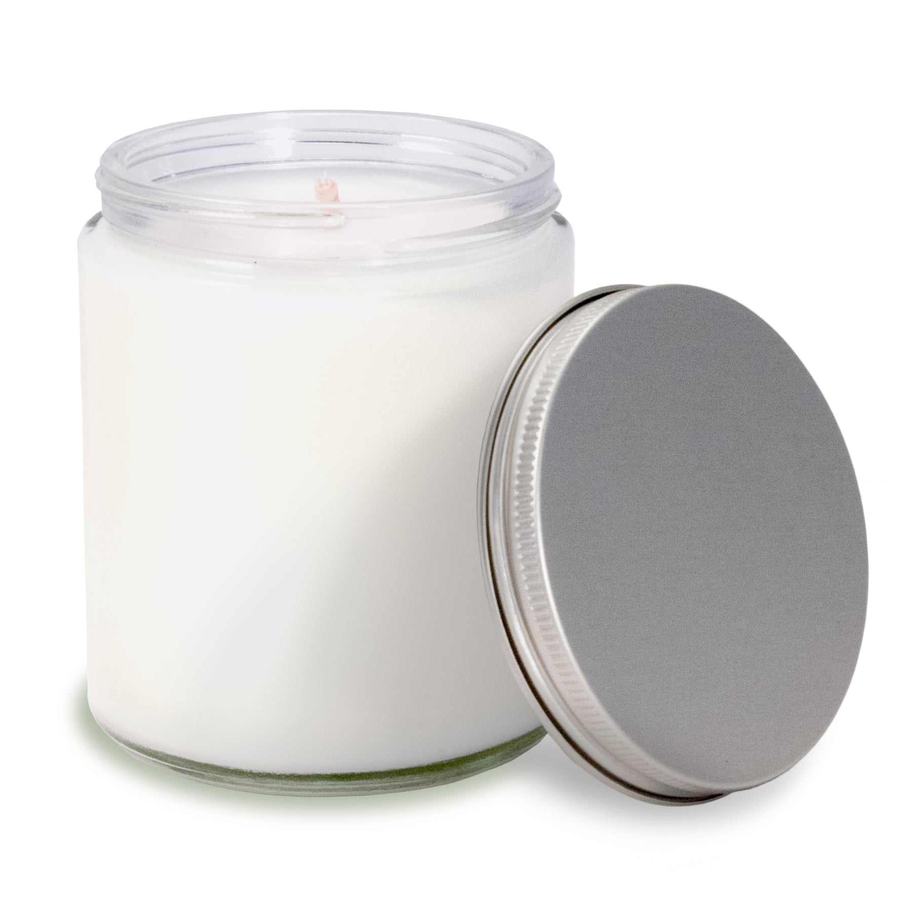 8 oz clear glass apothecary jar candle with silver screw-on lid off to the side.