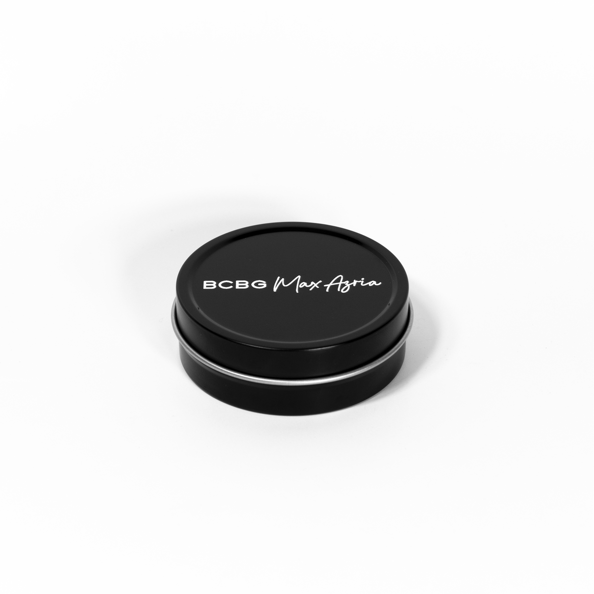 2 oz black tin travel candle shown with removable black lid featuring white text.