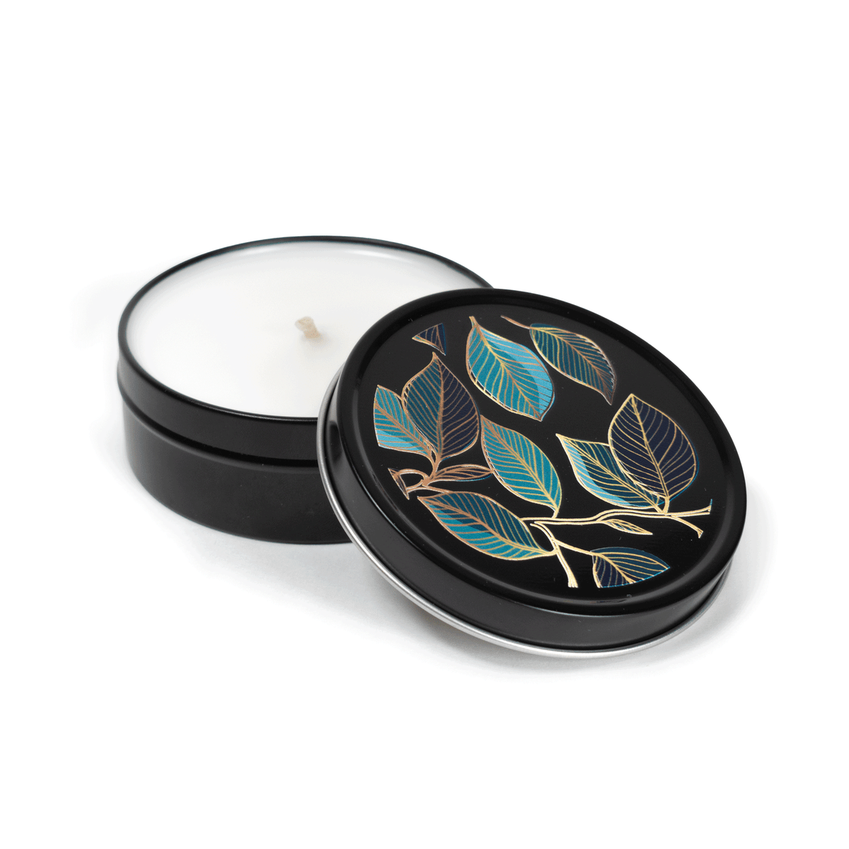 4 oz black tin travel candle with white wax and cotton wick, shown with removable black lid featuring multicolor imagery.