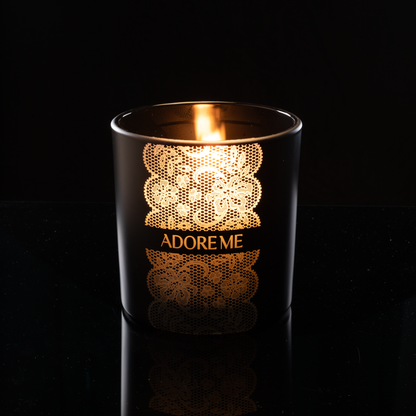 9 oz. Black glass candle with custom engraved logo from Bath Promotions, shown lit — Lit version