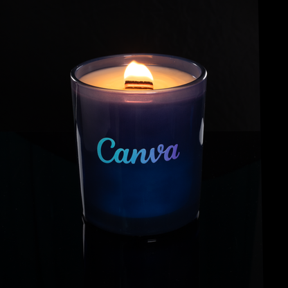 14 oz. Blue glass candle with custom printed logo from Bath Promotions, shown lit — Lit version