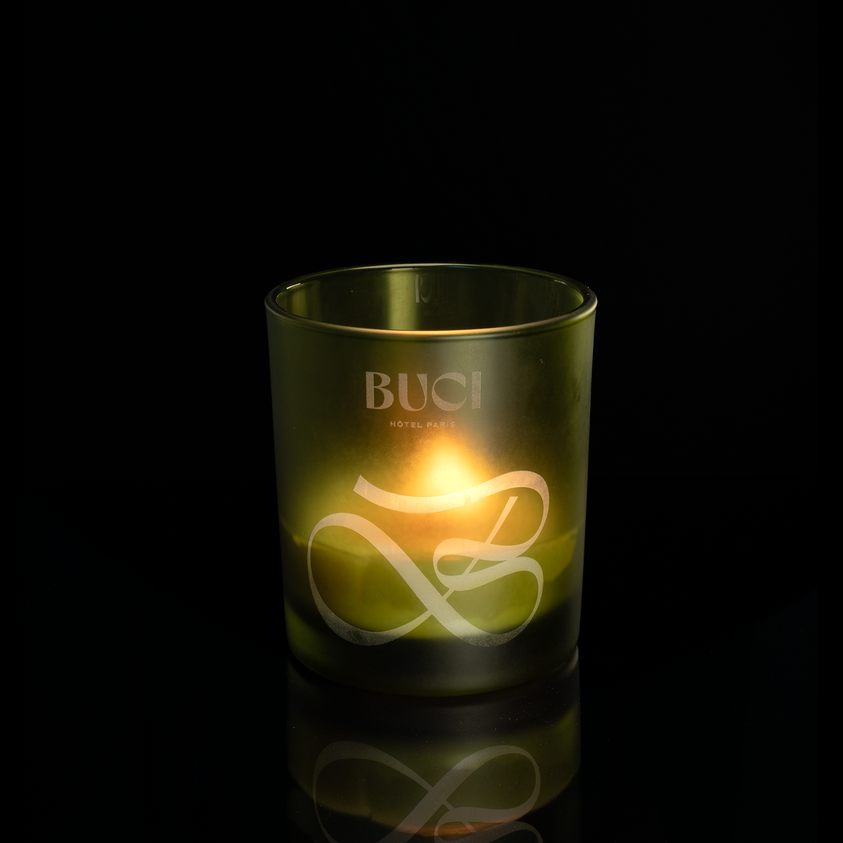 14 oz. Green glass candle with custom engraved logo from Bath Promotions, shown lit — Lit version