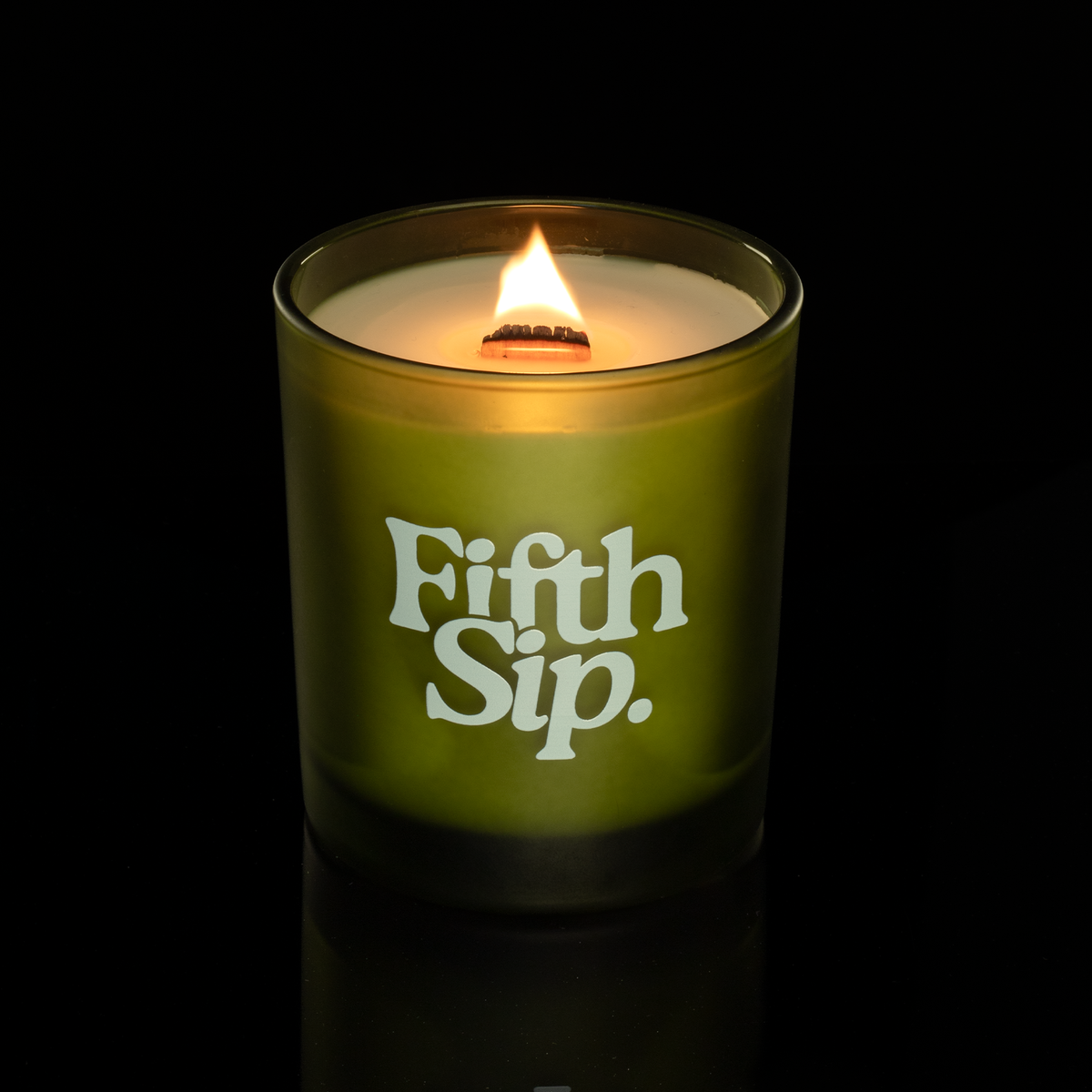 14 oz. Green glass candle with custom printed logo from Bath Promotions, shown lit — Lit version