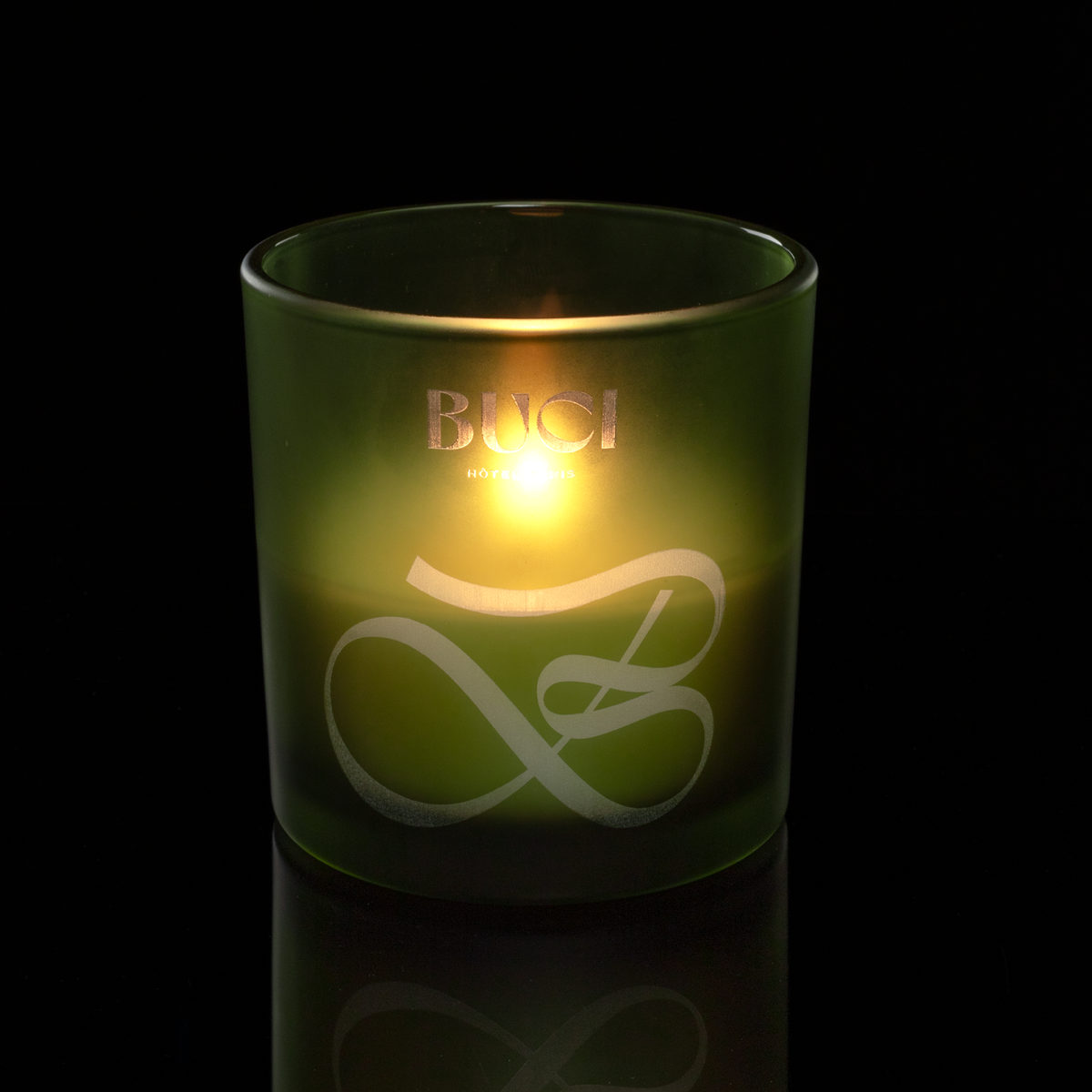 9 oz. Green glass candle with custom engraved logo from Bath Promotions, shown lit — Lit version
