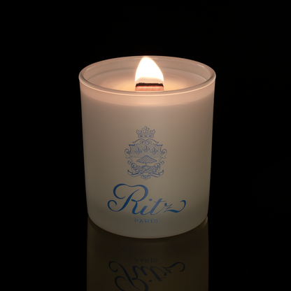 14 oz. Ivory glass candle with custom printed logo from Bath Promotions, shown lit — Lit version