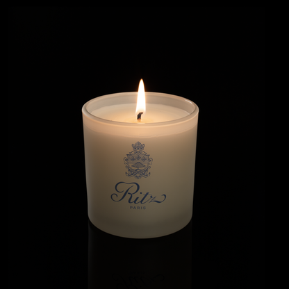 9 oz. Ivory glass candle with custom printed logo from Bath Promotions, shown lit — Lit version