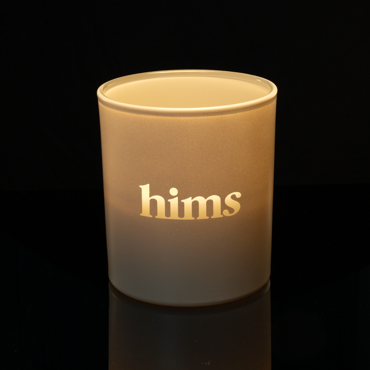 14 oz. Nude glass candle with custom engraved logo from Bath Promotions, shown lit — Lit version