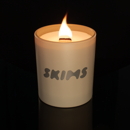14 oz. Nude glass candle with custom printed logo from Bath Promotions, shown lit — Lit version