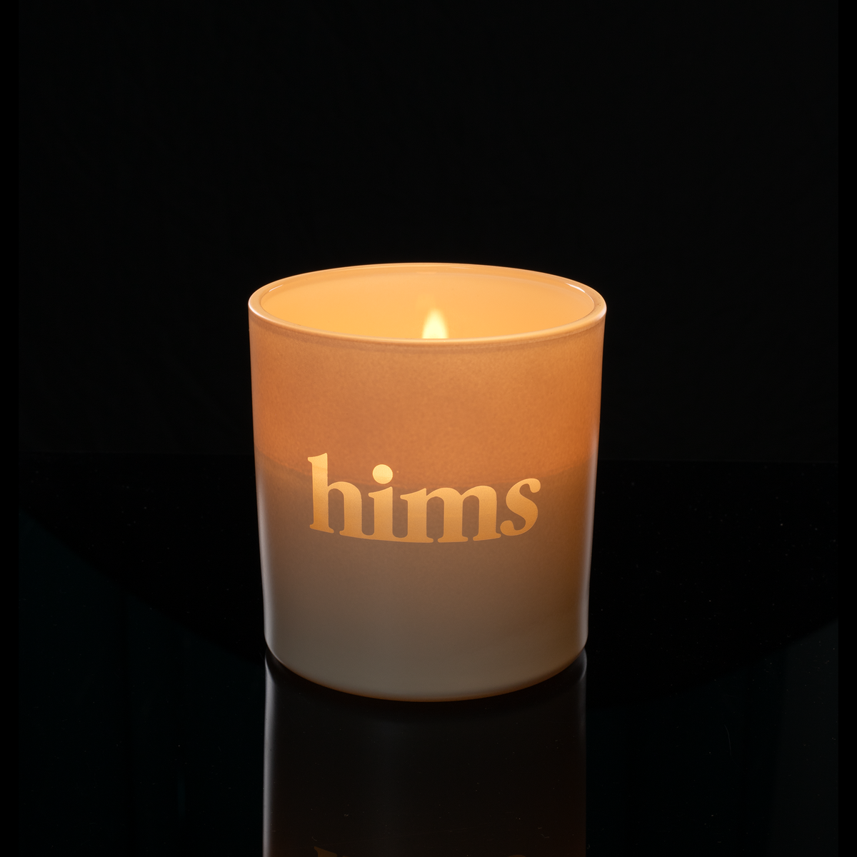 9 oz. Nude glass candle with custom engraved logo from Bath Promotions, shown lit — Lit version