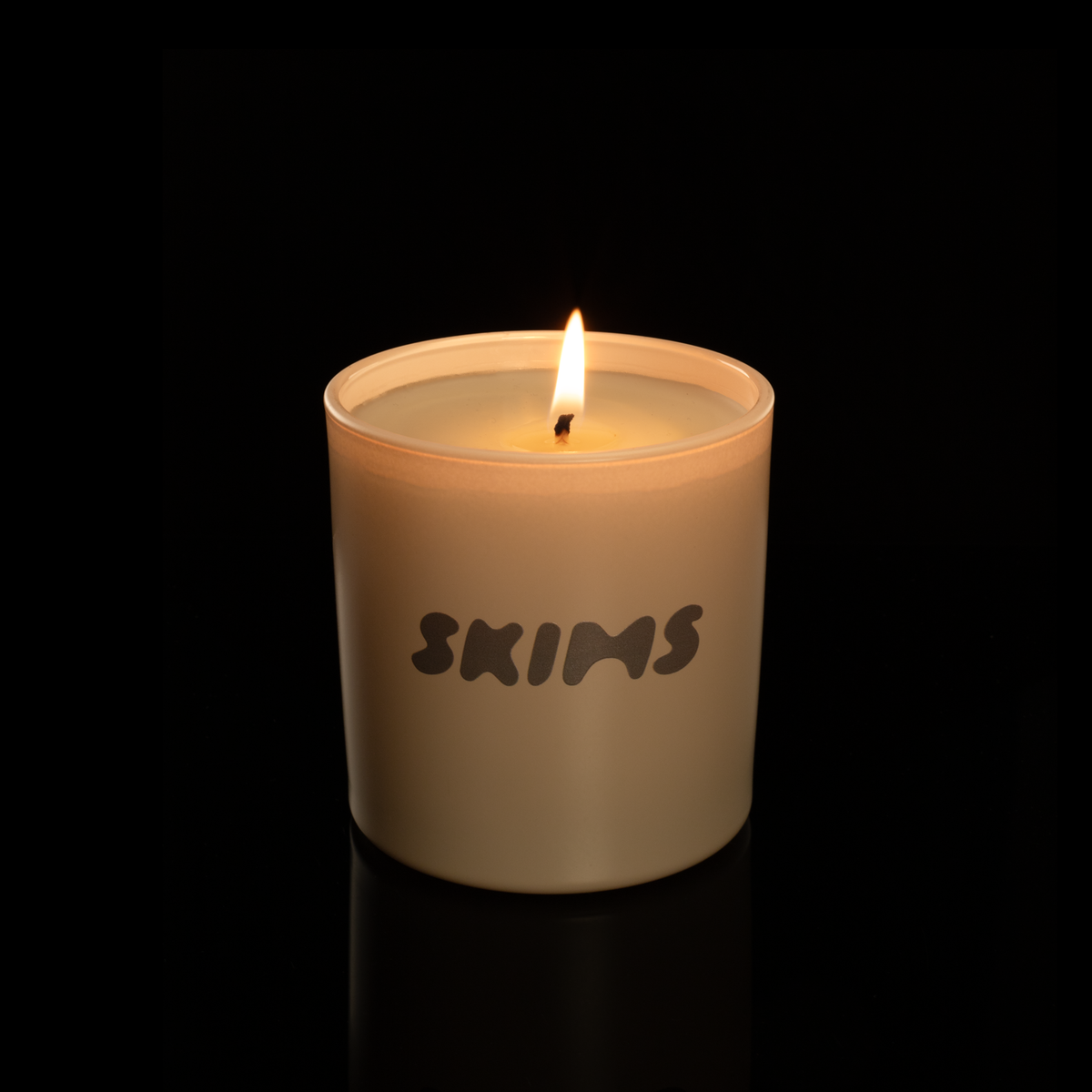 9 oz. Nude glass candle with custom printed logo from Bath Promotions, shown lit — Lit version