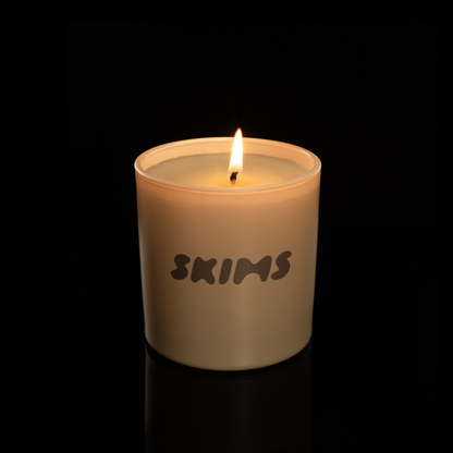 9 oz. Nude glass candle with custom printed logo from Bath Promotions, shown lit — Lit version