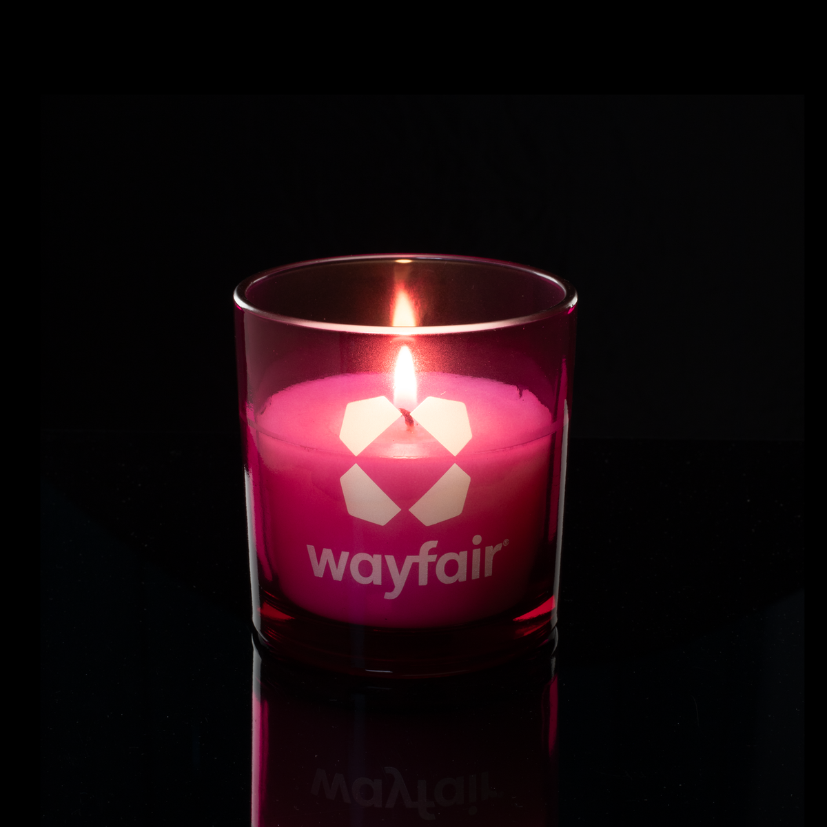 9 oz. Purple glass candle with custom engraved logo from Bath Promotions, shown lit — Lit version