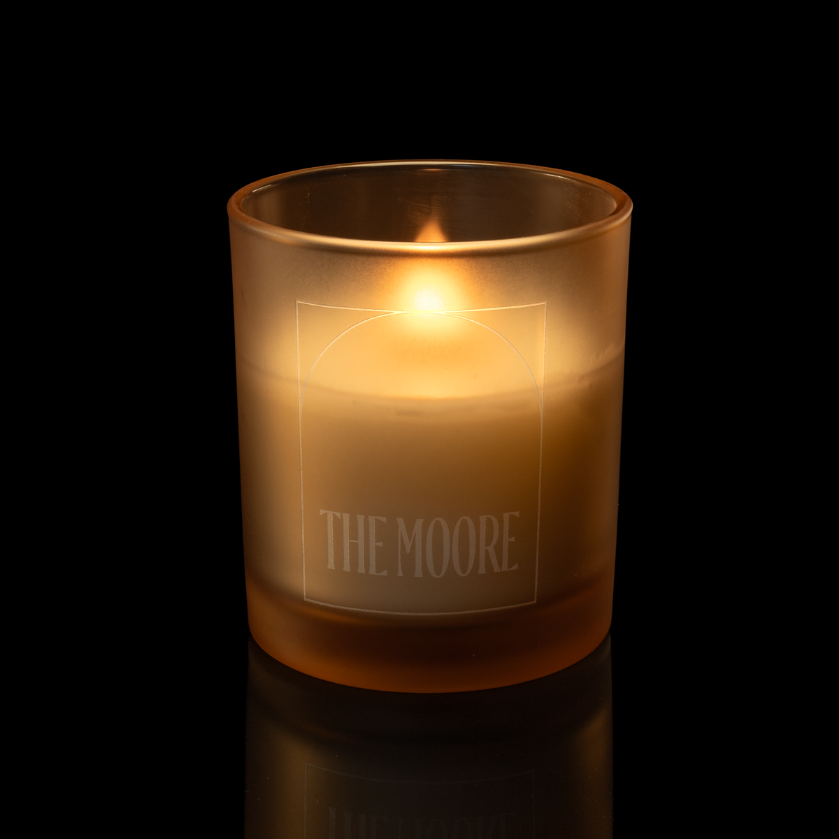14 oz. Sand glass candle with custom engraved logo from Bath Promotions, shown lit — Lit version
