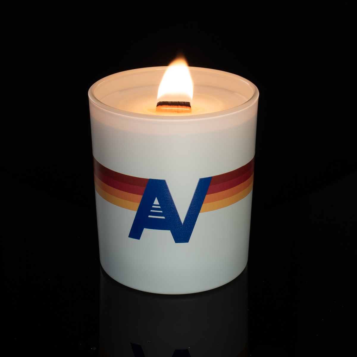 14 oz. White glass candle with custom printed logo from Bath Promotions, shown lit — Lit version