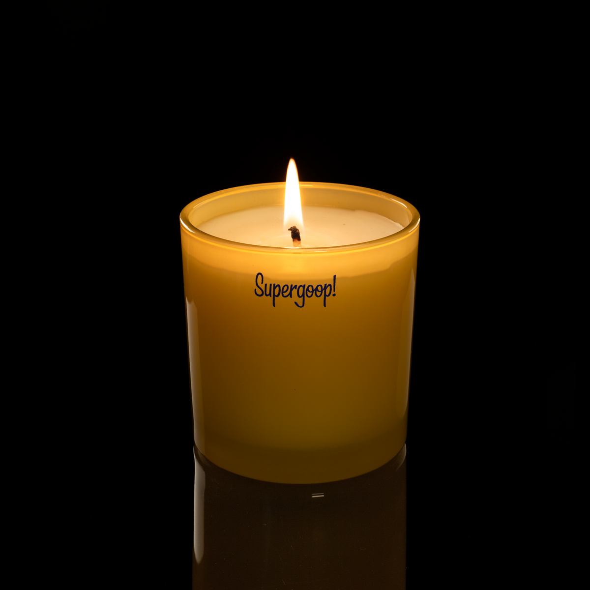 9 oz. Yellow glass candle with custom printed logo from Bath Promotions, shown lit — Lit version