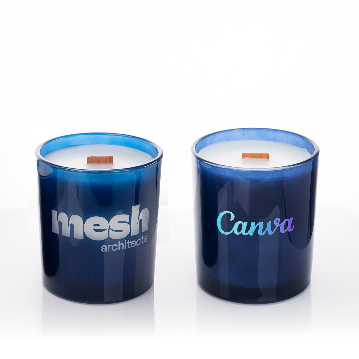 Blue glass, two 14 oz. candles side by side, one custom printed and one laser engraved, from Bath Promotions