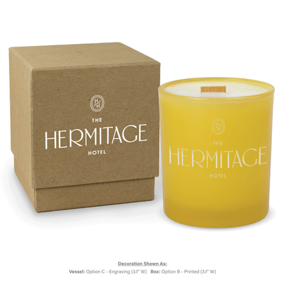 14 oz. Yellow glass candle with custom engraved logo next to its matching Kraft gift box