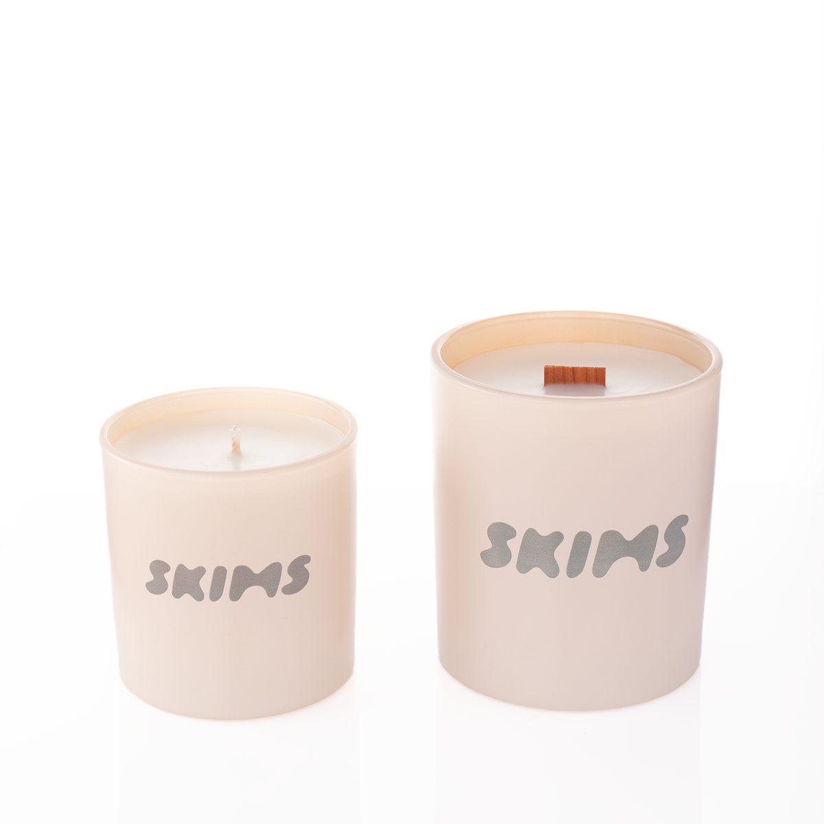 Nude glass candles, 9 oz. beside 14 oz., both custom printed with the same logo, from Bath Promotions