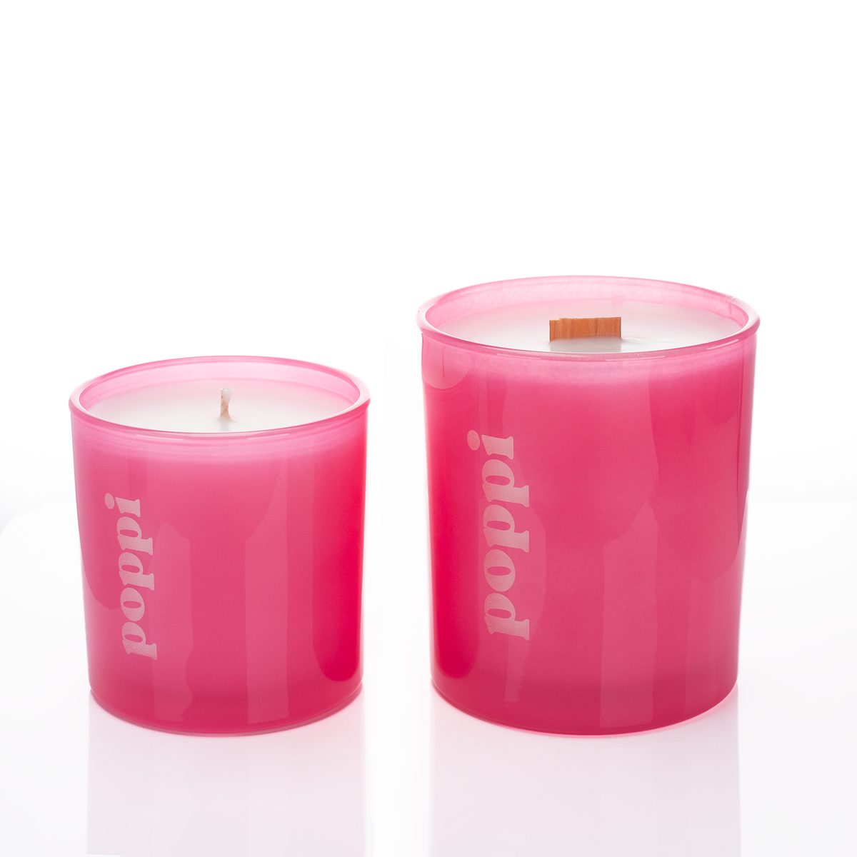 Pink glass candles, 9 oz. beside 14 oz., both laser engraved with the same logo, from Bath Promotions