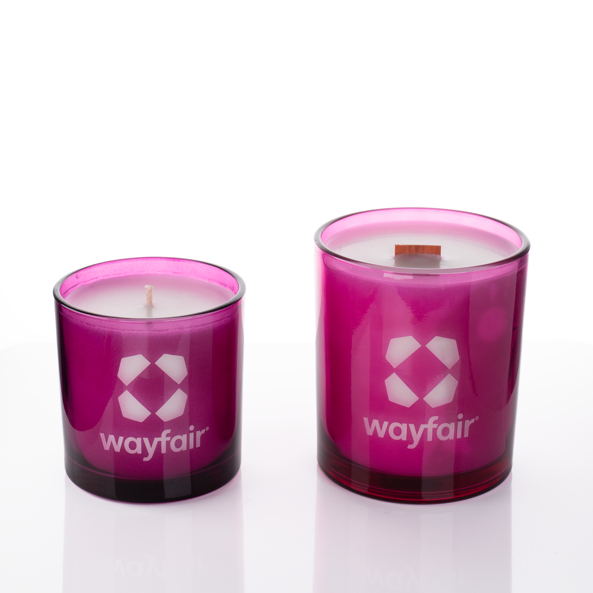 Purple glass candles, 9 oz. beside 14 oz., both laser engraved with the same logo, from Bath Promotions