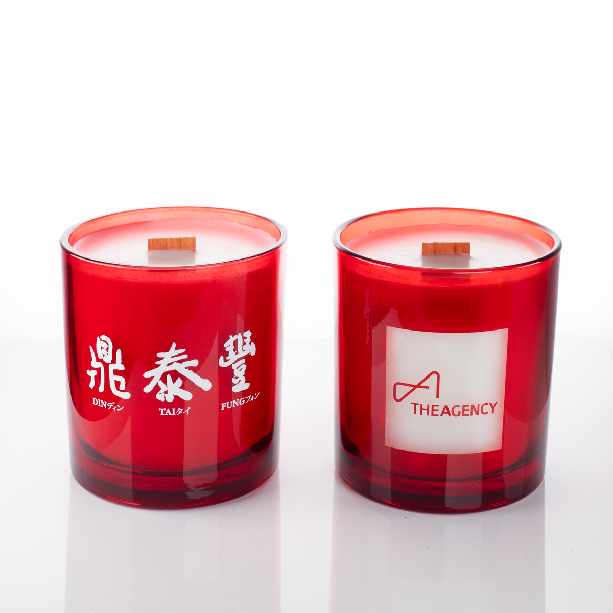 Red glass, two 14 oz. candles side by side, one custom printed and one laser engraved, from Bath Promotions
