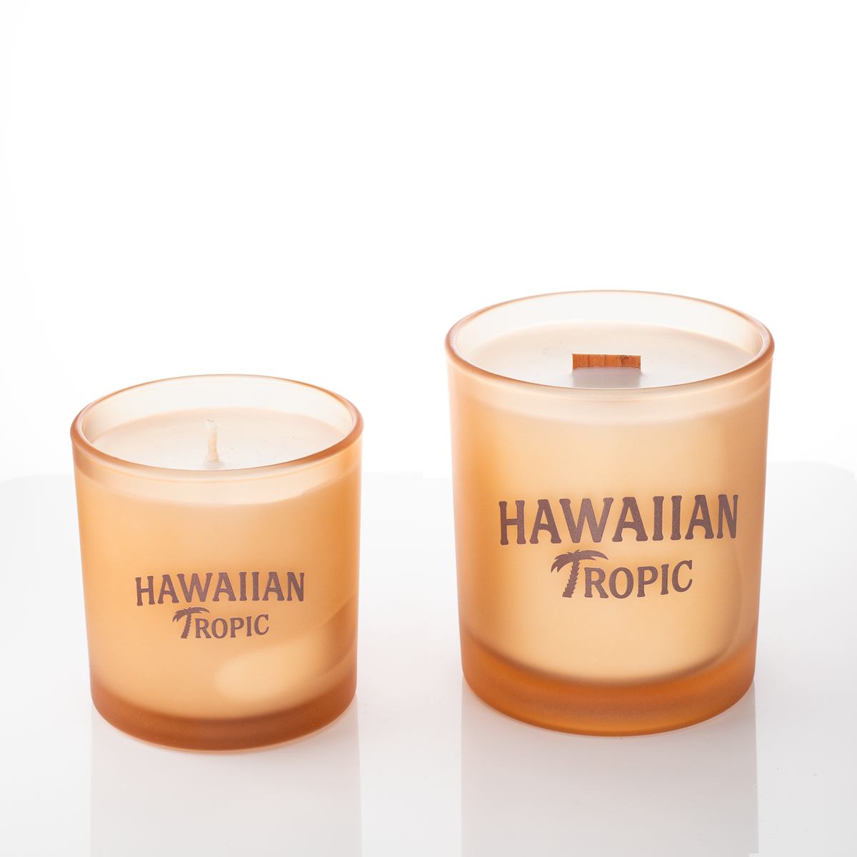 Sand glass candles, 9 oz. beside 14 oz., both custom printed with the same logo, from Bath Promotions