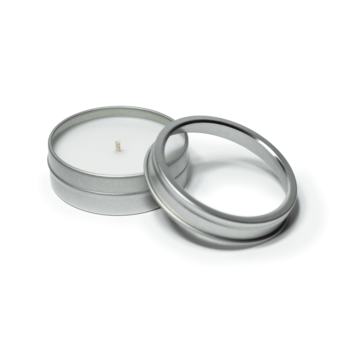2 oz open silver tin candle with white wax and cotton wick, alongside its clear  lid.