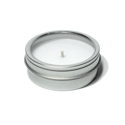 2 oz closed silver tin candle clear window displaying white wax and cotton wick.
