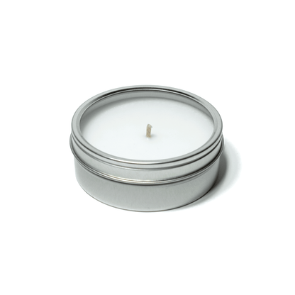 4 oz closed silver tin candle clear window displaying white wax and cotton wick.