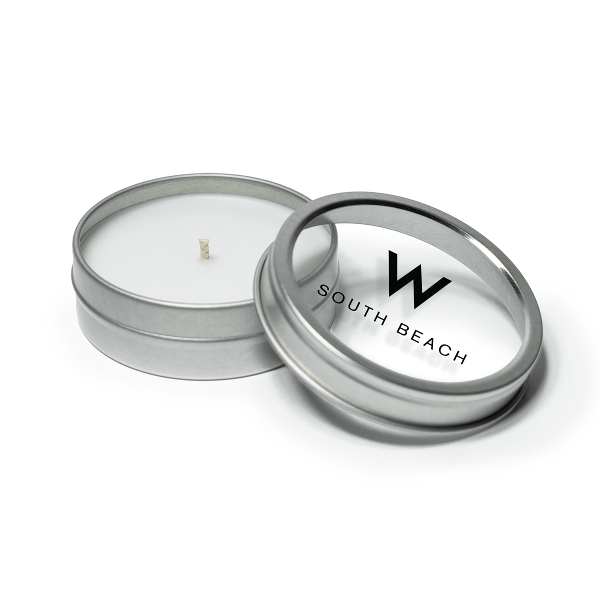 2 oz open silver tin candle with white wax and cotton wick, alongside its clear  lid displaying branding in black text.