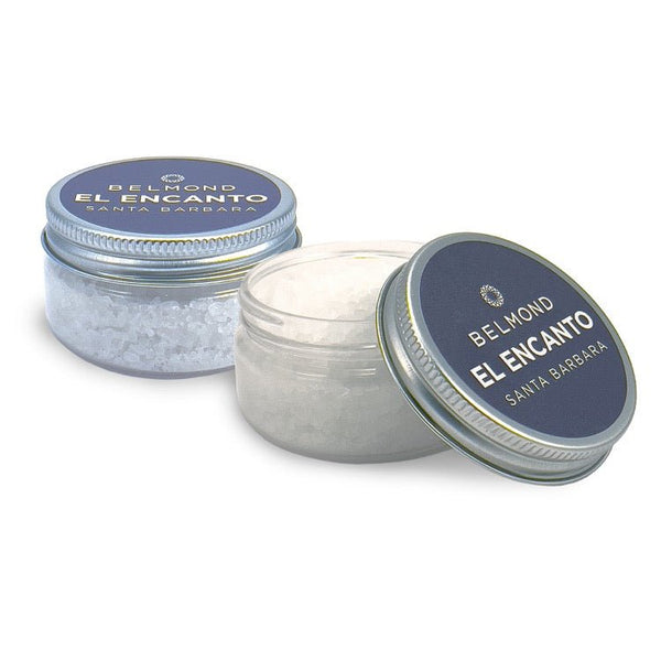 Two 3 oz clear jars with silver screw-on lids and blue labels. One jar is closed, the other is open revealing white bath salts inside.
