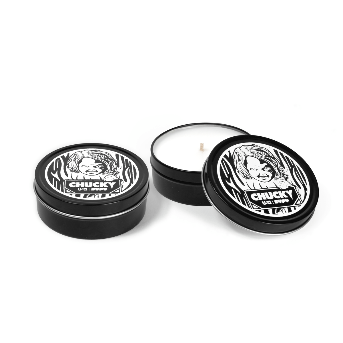 Two 4 oz black tin travel candles with white wax and cotton wicks, featuring white character design on lids - one closed and one open.