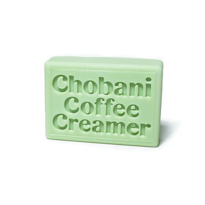 Light green rectangular bar soap with embossed logo.