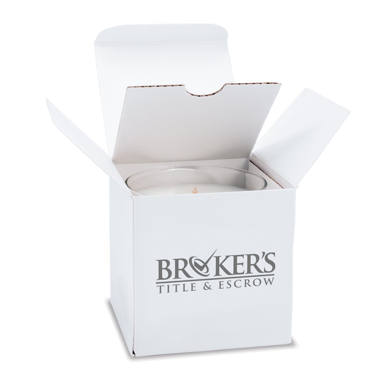 6 oz clear glass candle with white wax and cotton wick nestled inside an open white gift box decorated with bold gray logo.