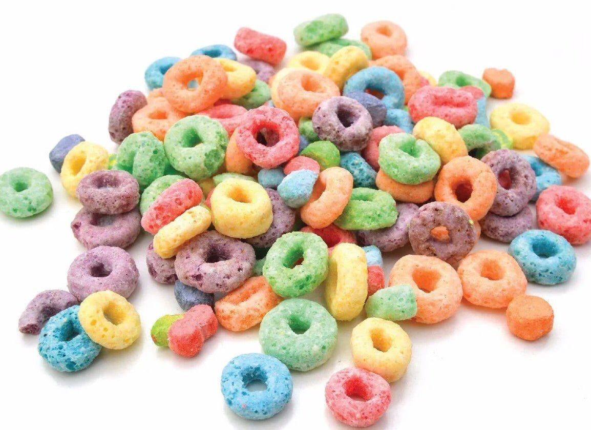 Colorful ring-shaped cereal pieces in bright colors including blue, green, yellow, orange, red, and purple on white background.