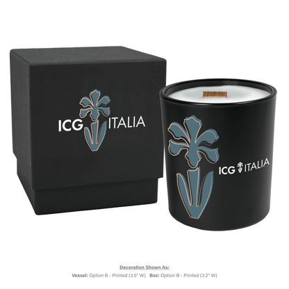 14 oz black glass candle with wooden wick and white wax next to matching black gift box, both featuring multicolor branding.